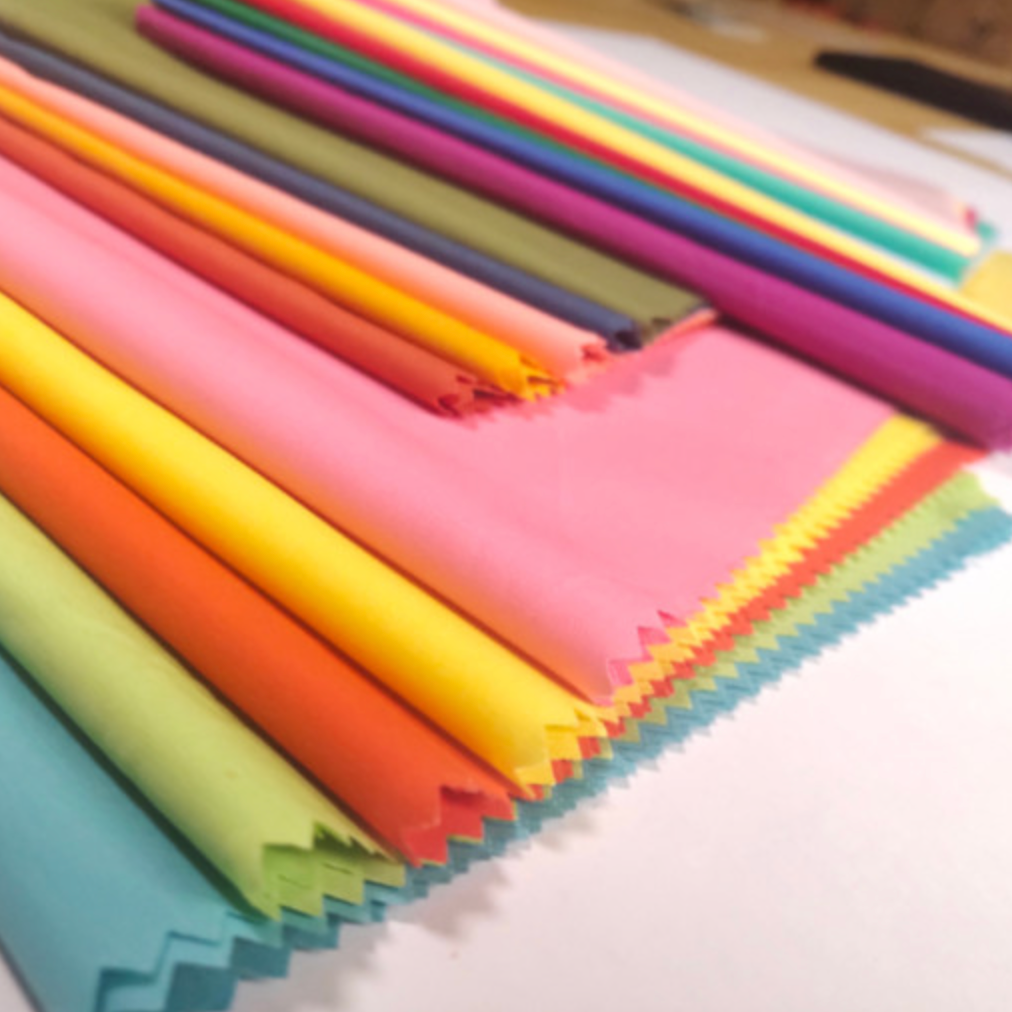 Personal color analysis fabric drapes in various shades for seasonal color diagnosis in Dubai. K-beauty-inspired color analysis using fabric swatches.